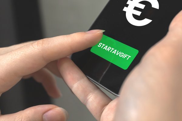a person holding a green button
