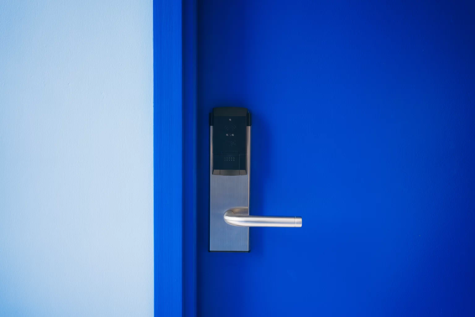 A blue door with a electronic lock