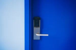 A blue door with a electronic lock